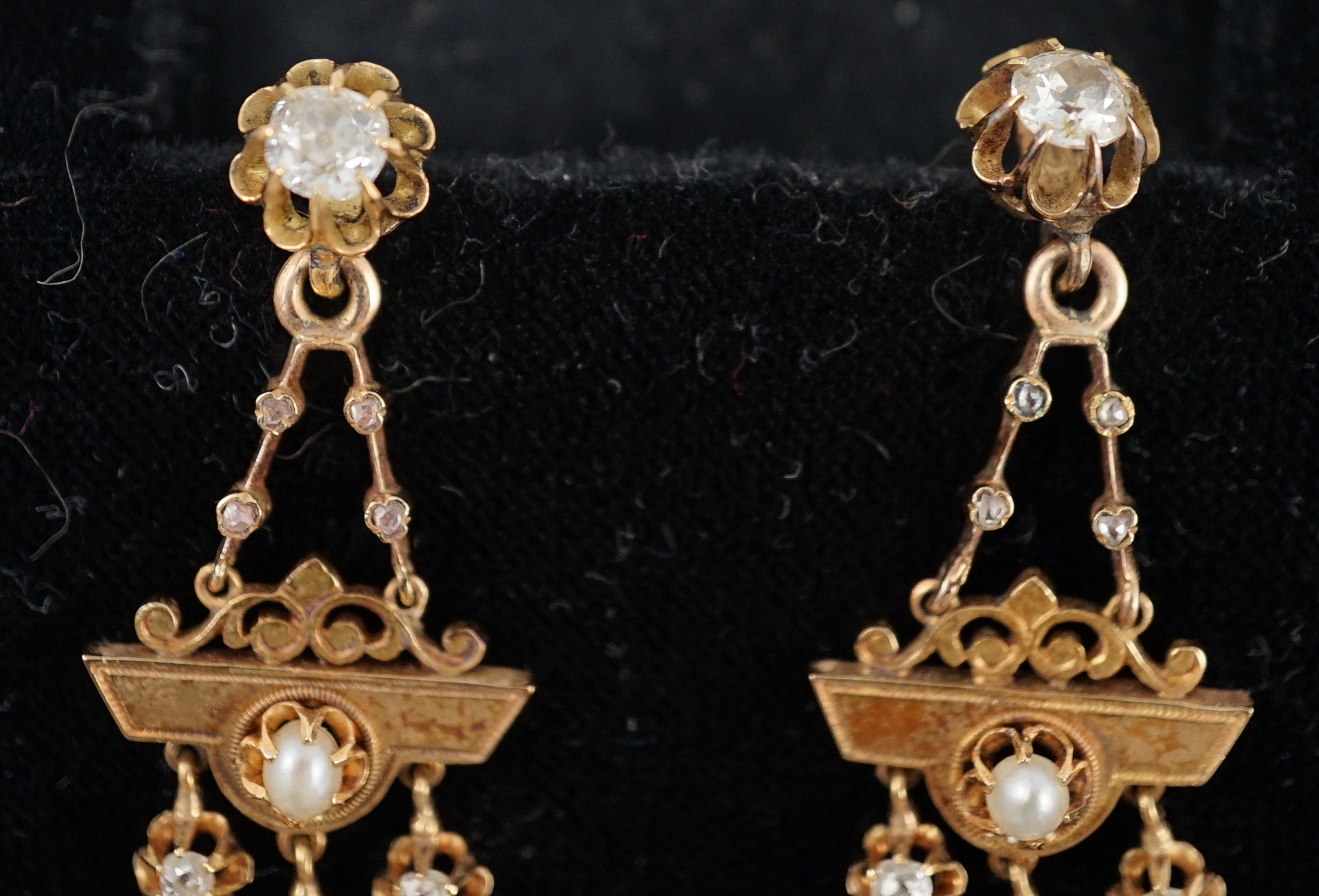 A pair of Victorian gold, seven stone diamond and two stone pearl set triple drop earrings, of aesthetic design